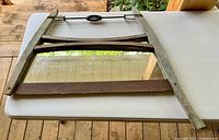 Full view of bow saw mirror on table