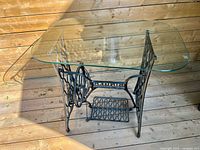 Overall view of glass-topped table on Singer base