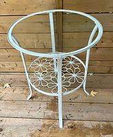 Full view of round cast iron and glass side table