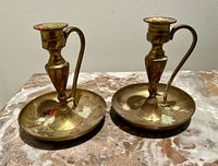 Front view of both brass chamber candlesticks