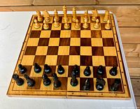 Chess set arranged on board