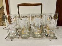Front view of six Libbey foliage highball glasses in metal carrier