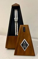 Metronome front with cover removed showing tempo scale and pendulum