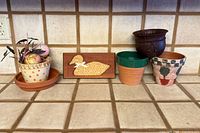 Group shot of five planters, duck plaque and artificial fruit