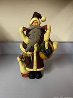 Front view of Williraye Studio Santa figurine holding goose and basket