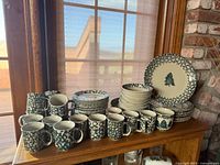 Full set of plates and mugs on shelf