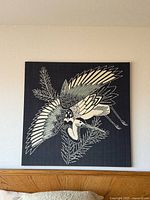 Front view of large square heron artwork on wall