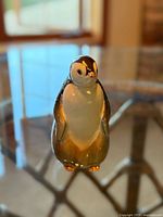 Front view of standing porcelain penguin figurine