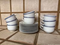 Front view showing stacked plates flanked by stacked cups