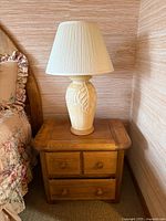 Full view of lamp on nightstand shows body, shade, color, style