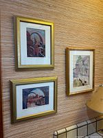 Three framed prints on wall