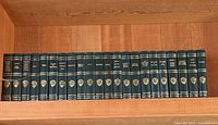 Full shelf view showing all 20 matching green Harvard Classics volumes
