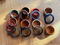All 18 bangles laid out in three rows on wooden surface