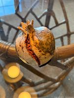 Top view of ceramic pomegranate showing crown and split interior