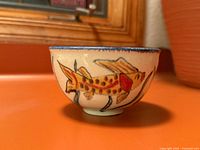 Side view showing fish decoration and bowl profile