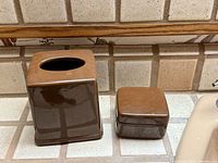 Tissue box cover and trinket box side by side showing color and shape