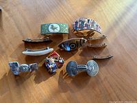 All eight barrettes arranged on wooden surface