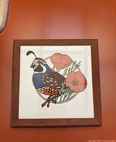 Front view of framed ceramic tile showing quail and poppies design