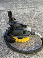 Full view of Ridgid portable shop vac showing canister, hose and cord