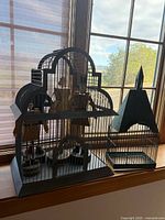 Domed and steeple roof metal birdcages on windowsill