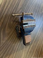 Top view of blue cast-iron bench vise showing jaws and T-handle