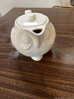 Top view of white ceramic owl teapot showing lid and beak-shaped spout