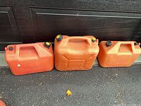 Three plastic gasoline jugs