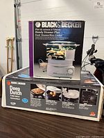 Boxed Black & Decker Handy Steamer Plus and Deep Dutch skillet on table