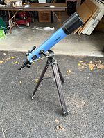 Full view of blue Sky-Watcher refractor telescope on tripod