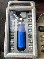 Blue-handled socket driver set in grey plastic case