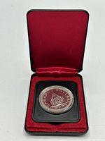 Coin in open clamshell case