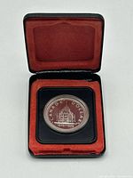 Closed presentation case with coin visible