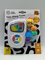 Front view of factory-sealed Baby Einstein Take Along Tunes musical toy in retail blister pack