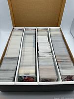 4-row storage box open, showing rows packed with sleeved hockey cards