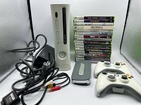 Console, controllers, hard drive, power supply, AV cable, and game stack