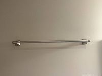 Full frontal view of towel rod mounted on wall
