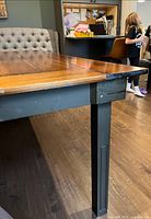 Close-up of table leg, apron and plank top corner