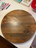 Top view of round wooden lazy Susan showing grain and text