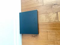 Front view of one chocolate-brown square shelf mounted on wall