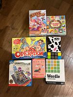 Seven boxed games arranged on floor
