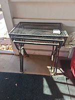 Three stacked wrought iron nesting tables