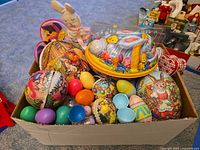 Box overview showing papier-mâché eggs, plastic eggs, bunny dish, plush rabbits