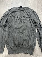Full view of grey Giorgio Armani sweater front side