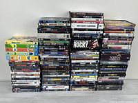 Wide shot showing three tall stacks and several multi-disc cartoon/TV sets