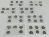 All nine sealed five-coin strips laid out