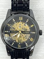 Front view showing skeleton dial, brand, markers