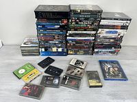 Full lot overview showing stacks of DVDs, CDs and cassette tapes