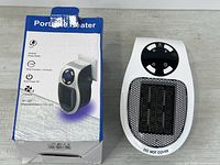 Heater front view beside retail box