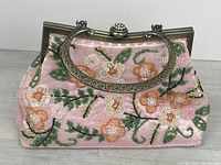 Front view showing floral bead embroidery and metal handle