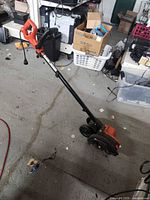 Full view of Black+Decker electric edger standing on floor